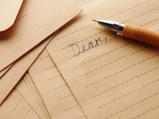 Letter with Dear written on it & pen