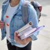 High school student carrying books