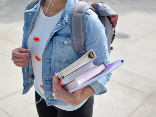 High school student carrying books