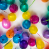 a bunch of colorful balloons are arranged in a circle