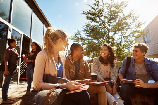 Shot of a group of students studying outside on campus