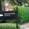 Close up of admissions office sign near public university campus