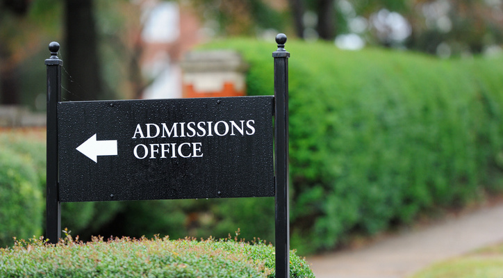 Close up of admissions office sign near public university campus
