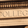 Stone building facade with ornate gold trim and the engraved word “COLLEGE” across a beige panel, framed by decorative columns and moldings.